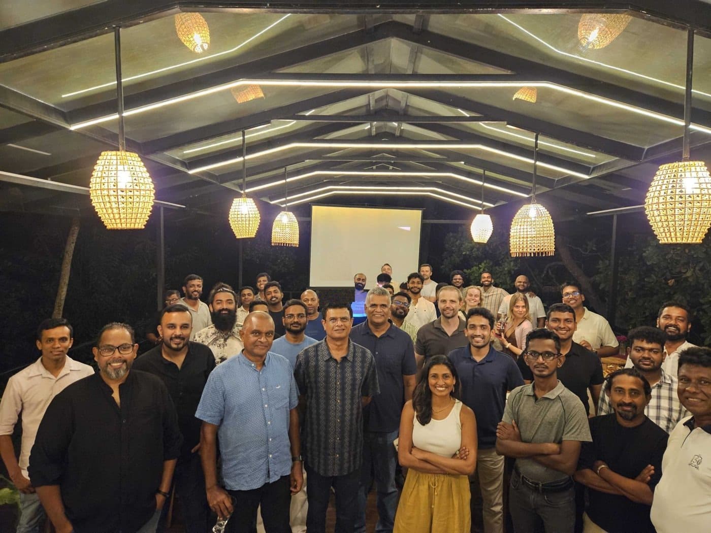 Around fifty founders and partners gathered under the lantern-lit roof of an open-air pavilion